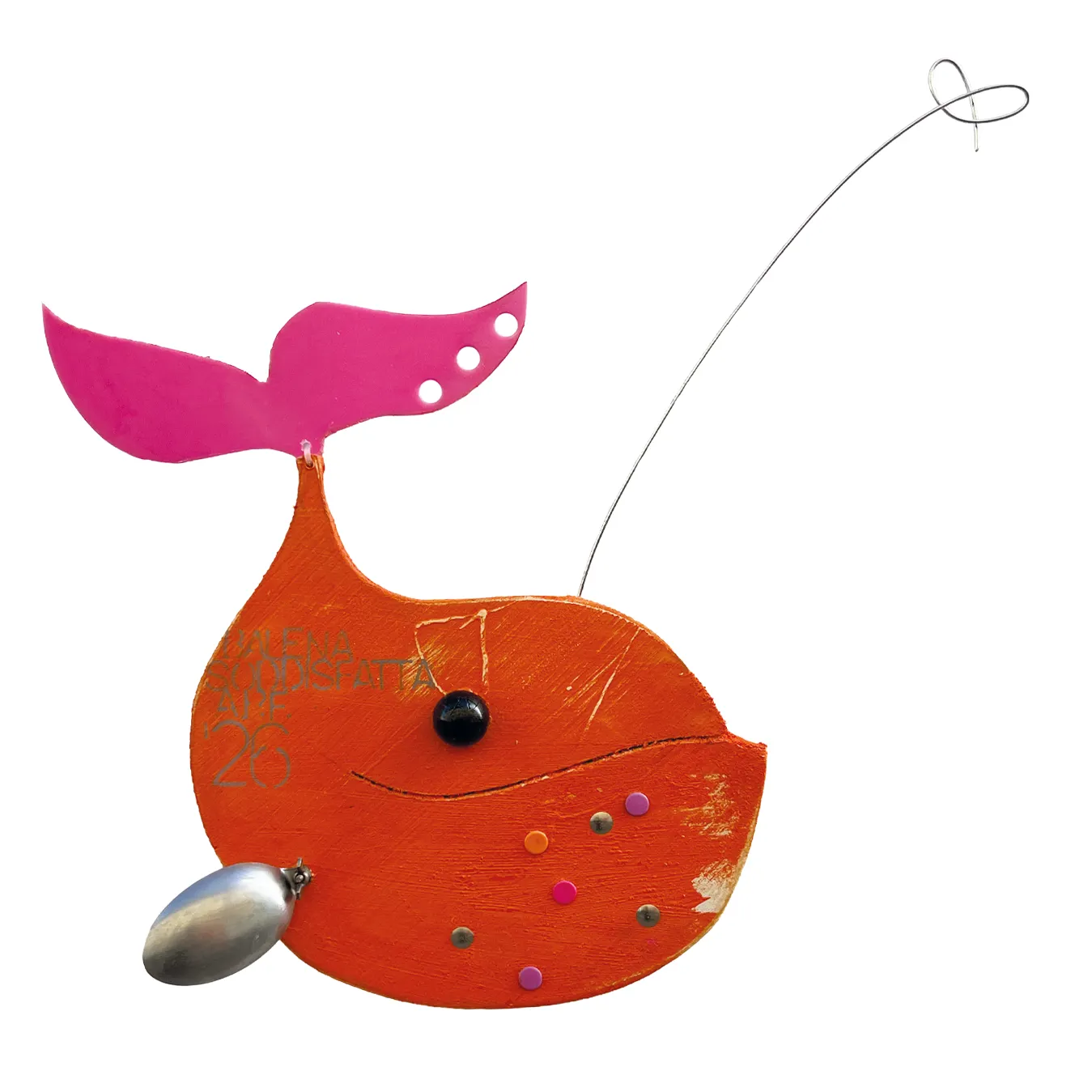 Scultura a parete in legno arancione a forma di balena sorridente con coda fucsia, pinna in metallo a cucchiaio e la scritta BALENA SODDISFATTA A.P.F. '26
